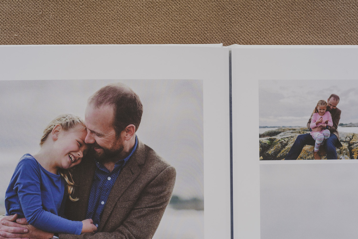beautiful family photo book-dad snuggling young daughter at beach