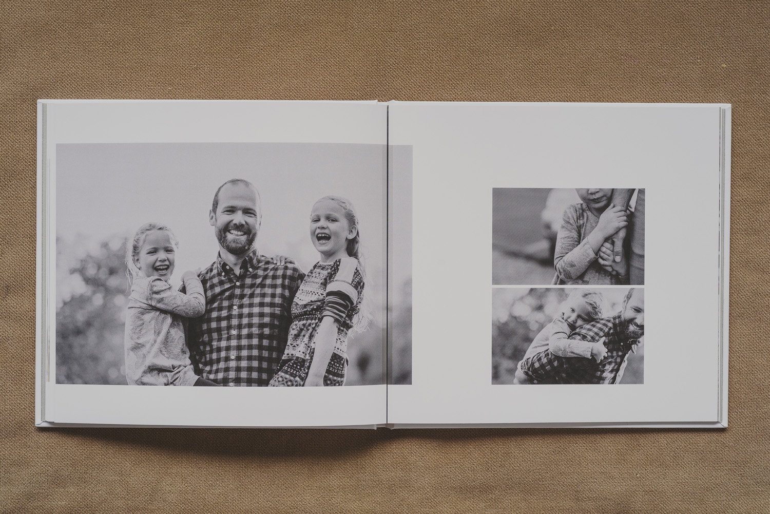 beautiful family photo book-dad holding 2 young girls all smiling