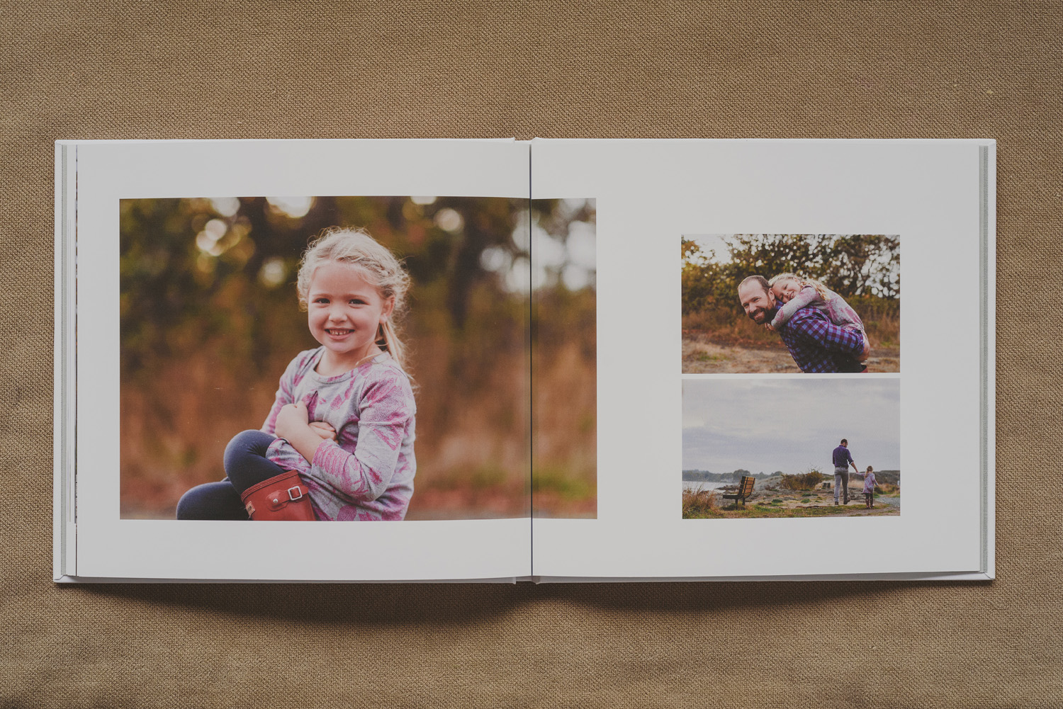 beautiful family photo book-young girl smiling & snuggling her dad