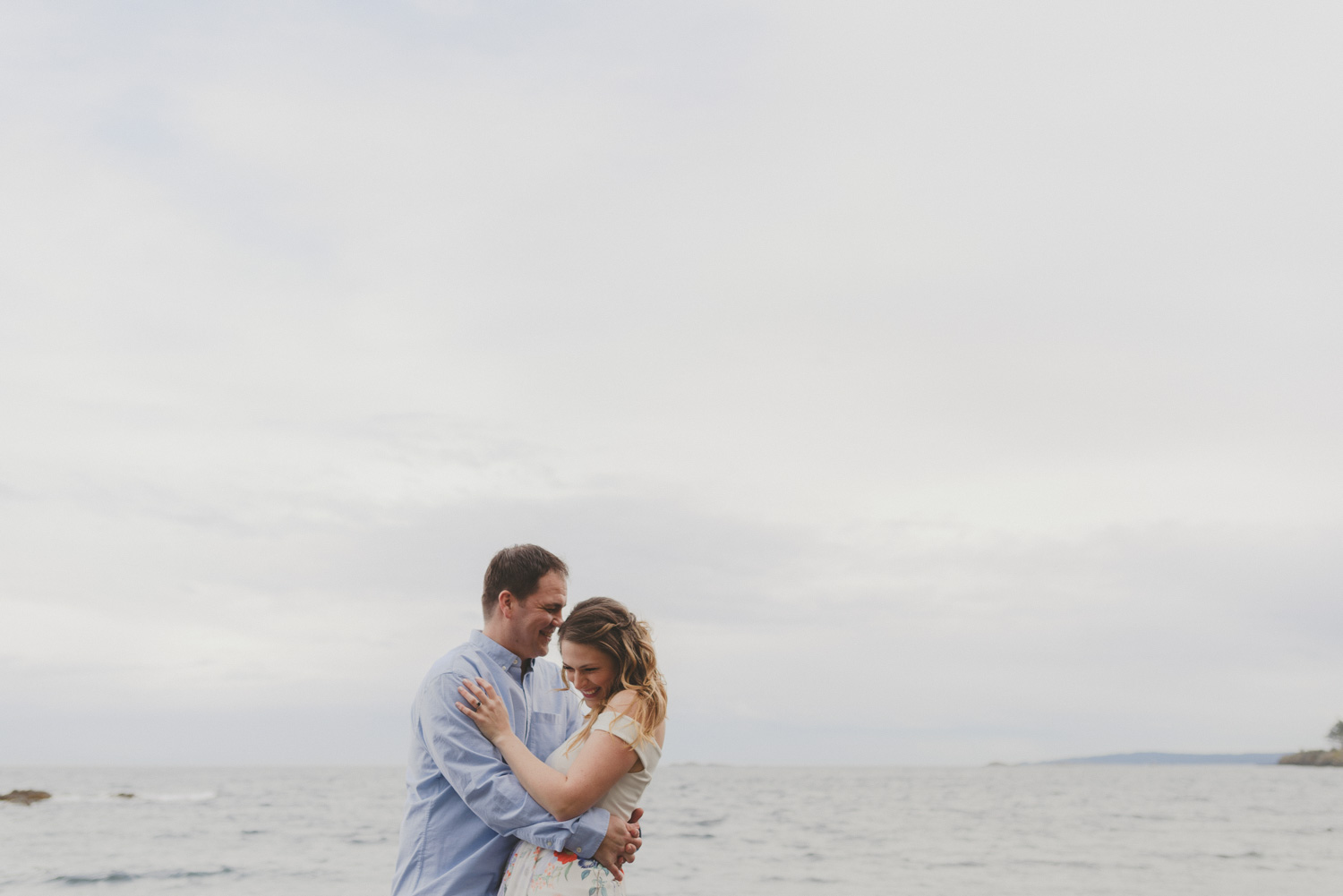 vancouver-island-bc-engagement-couple laughing by the ocean