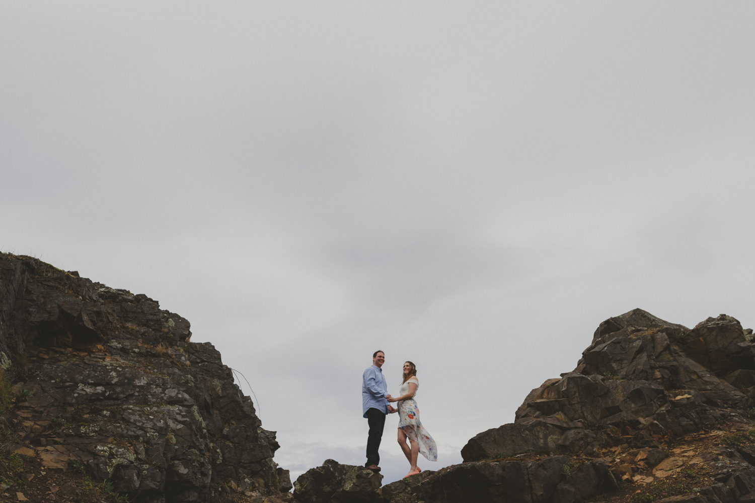 vancouver-island-bc-engagement-couple overlooking the ocean by a rocky outcropping
