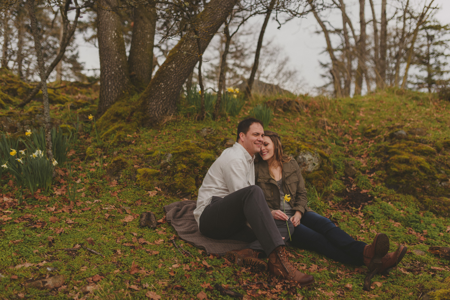 vancouver-island-bc-engagement-couple laughing in a mossy grove