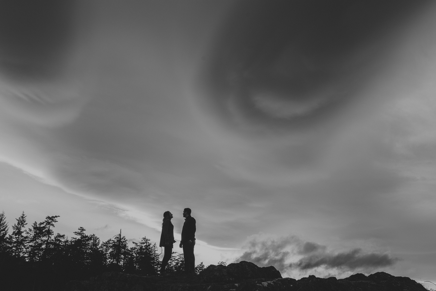 vancouver-island-bc-engagement-couple silhouetted by a dramatic sky