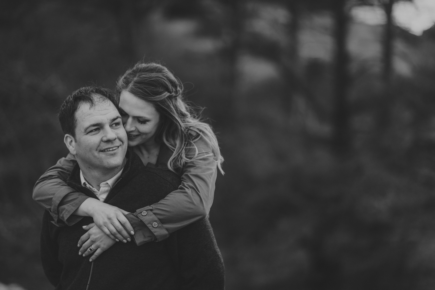 vancouver-island-bc-engagement-woman with her arms wrapped around her fiancé