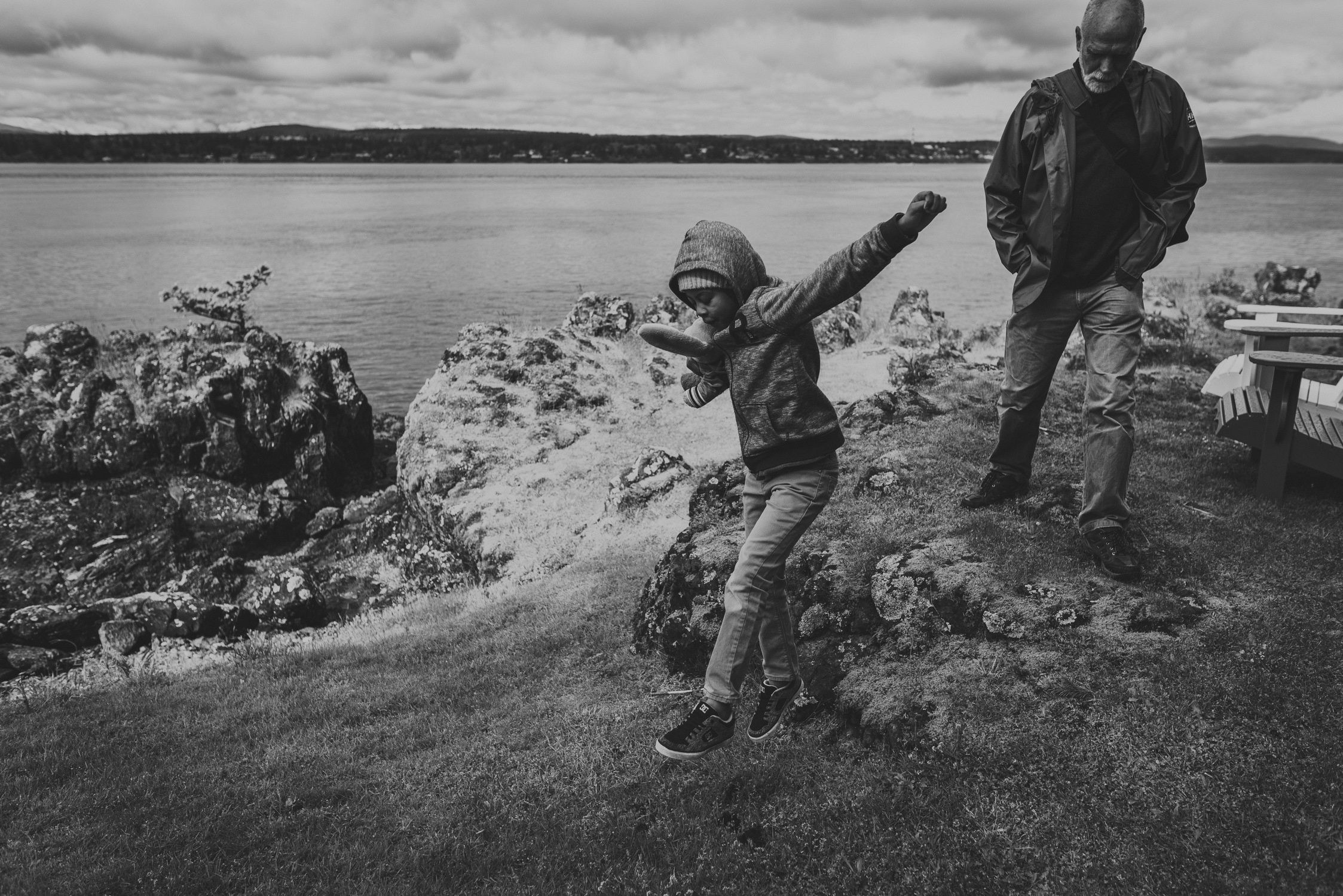 family travels - campbell river-father & kid jumping by the ocean 