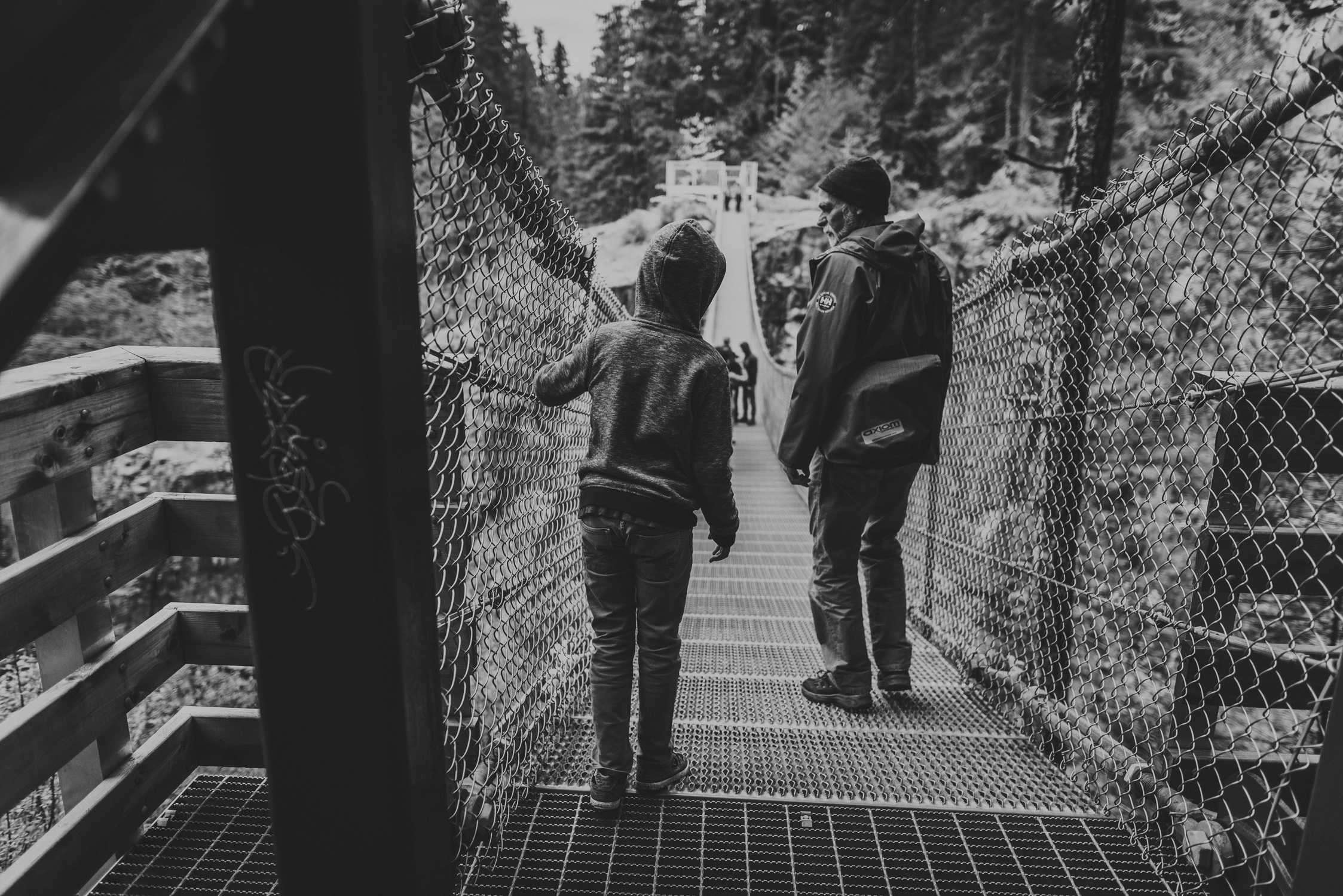family travels - campbell river-father & kid at entry to suspension bridge