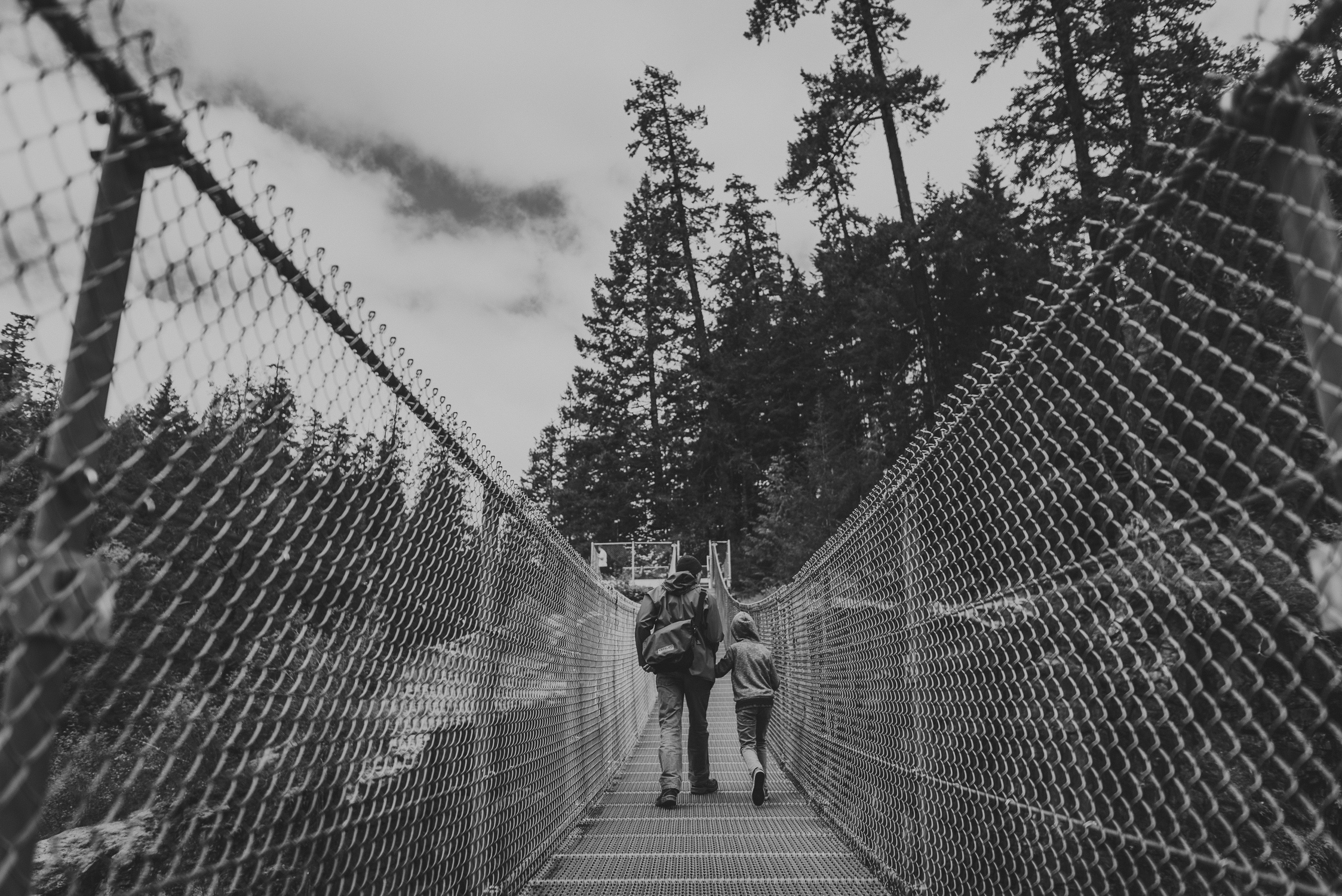 family travels - campbell river-father & kid walking on suspensions bridge