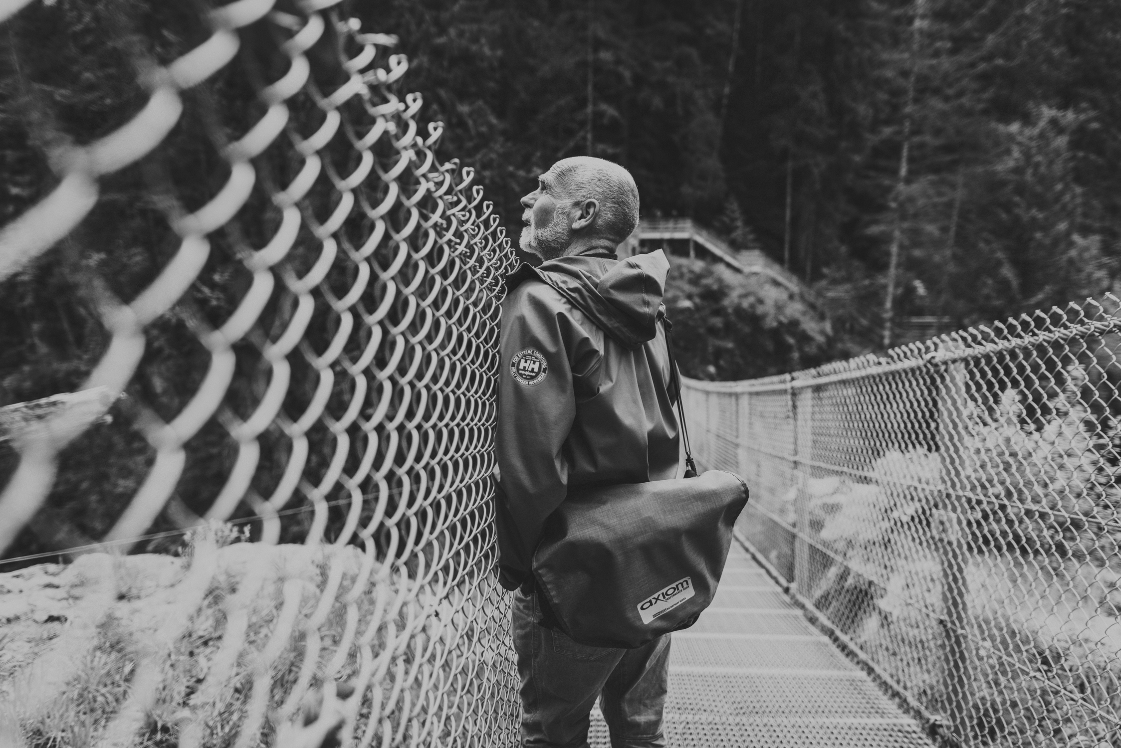 family travels - campbell river-man looking out over side of suspension bridge