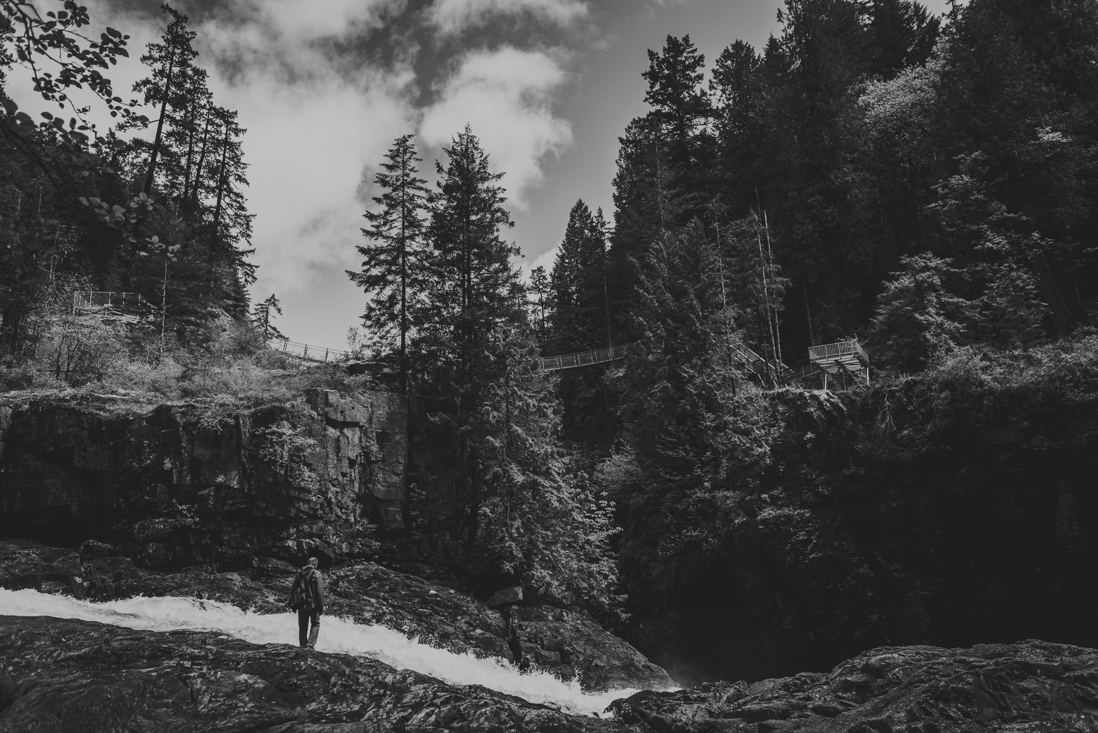 family travels - campbell river-man standing beside a flowing river