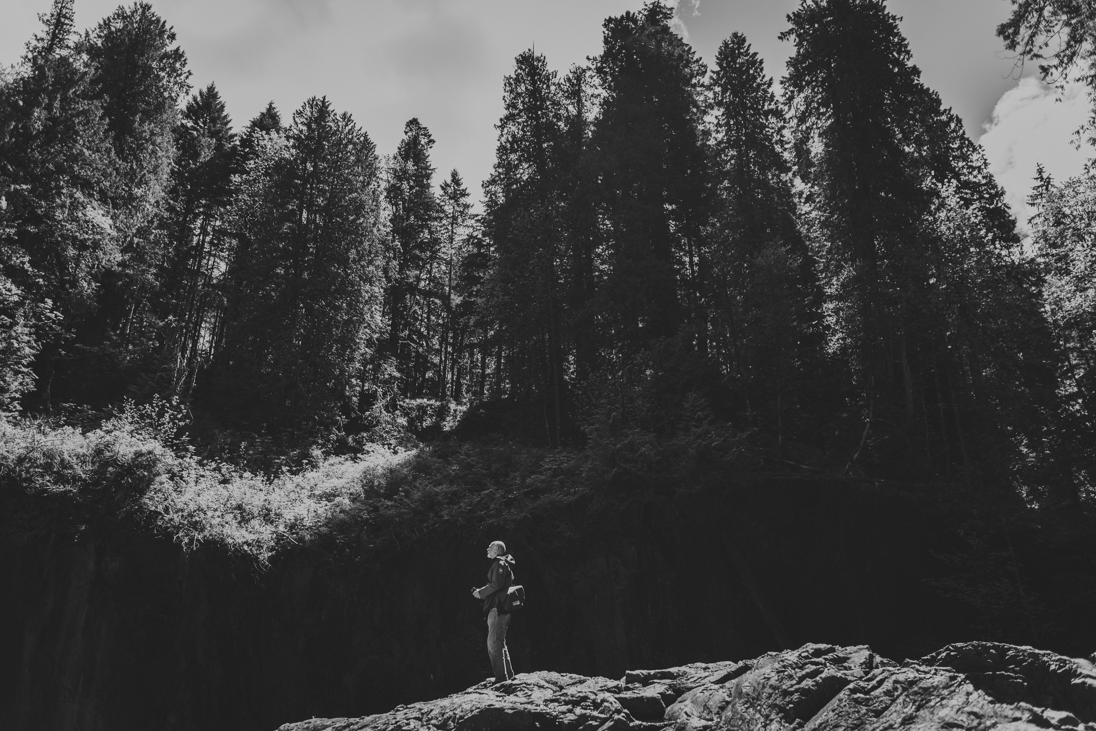 family travels - campbell river-man standing in front of forest