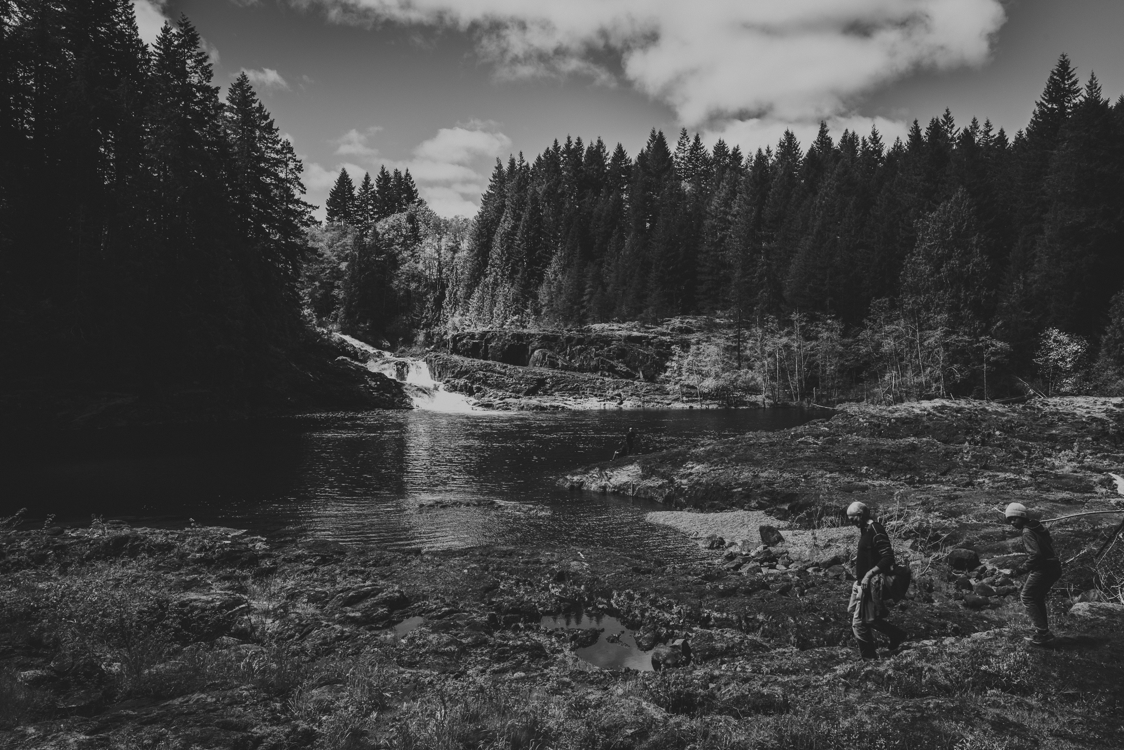 family travels - campbell river-father & kid walking toward water falls 
