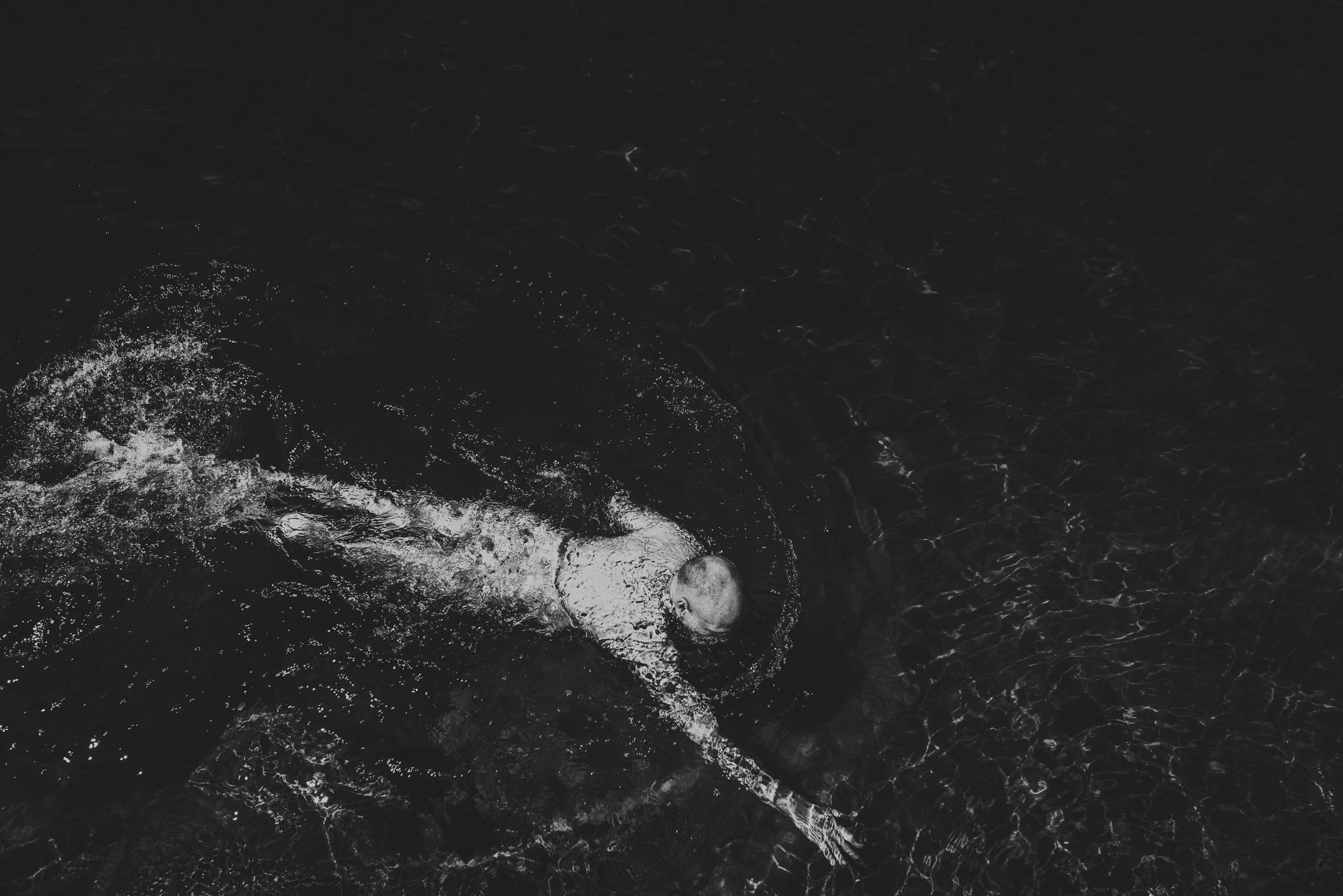 family travels - campbell river-looking down at man swimming naked in lake