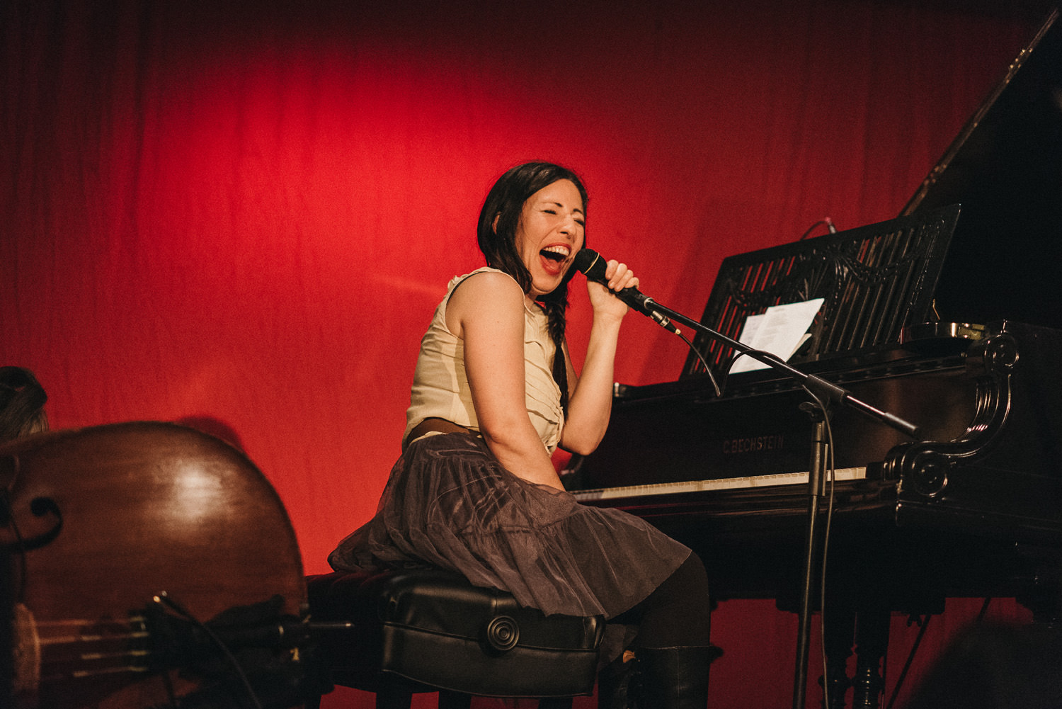 female singer songwriter laughing - on stage - hornby island