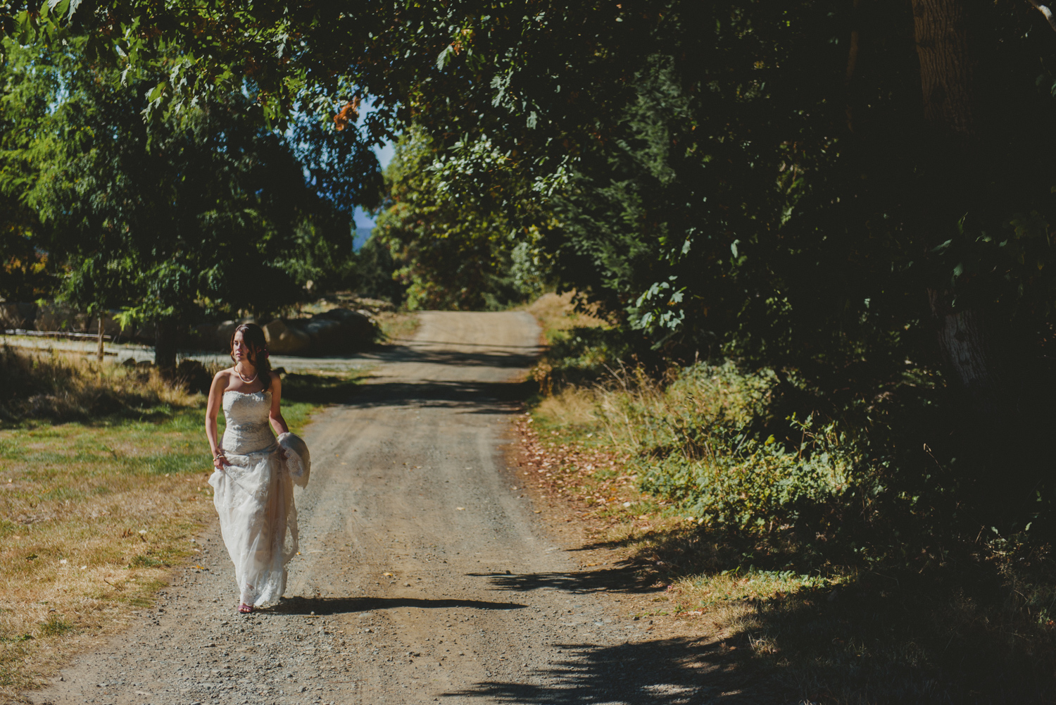 bride walking alone a path at bodega ridge galiano island