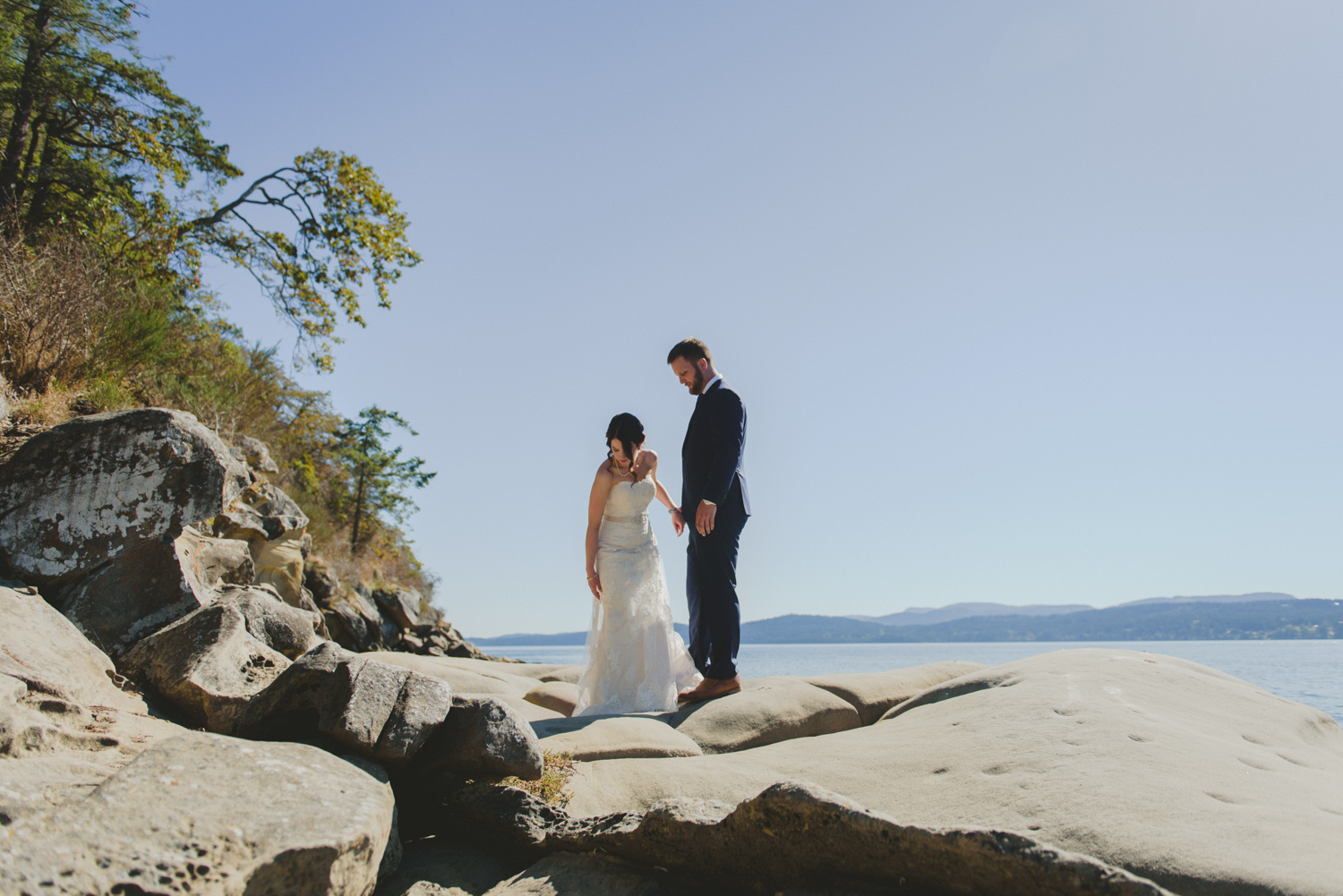 bride & groom by sandstone rocks at bodega ridge galiano island