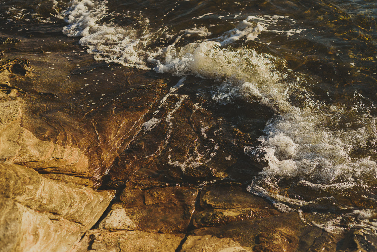 waves on the sandstone rocks - overbury resort thetis island wedding - 