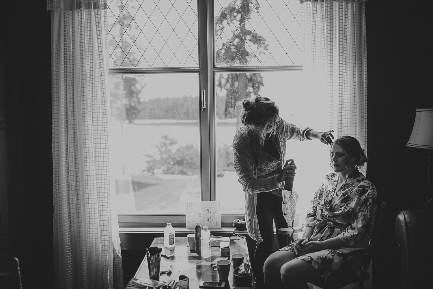 bride getting her hair done in front of a large window at overbury resort thetis island wedding - 