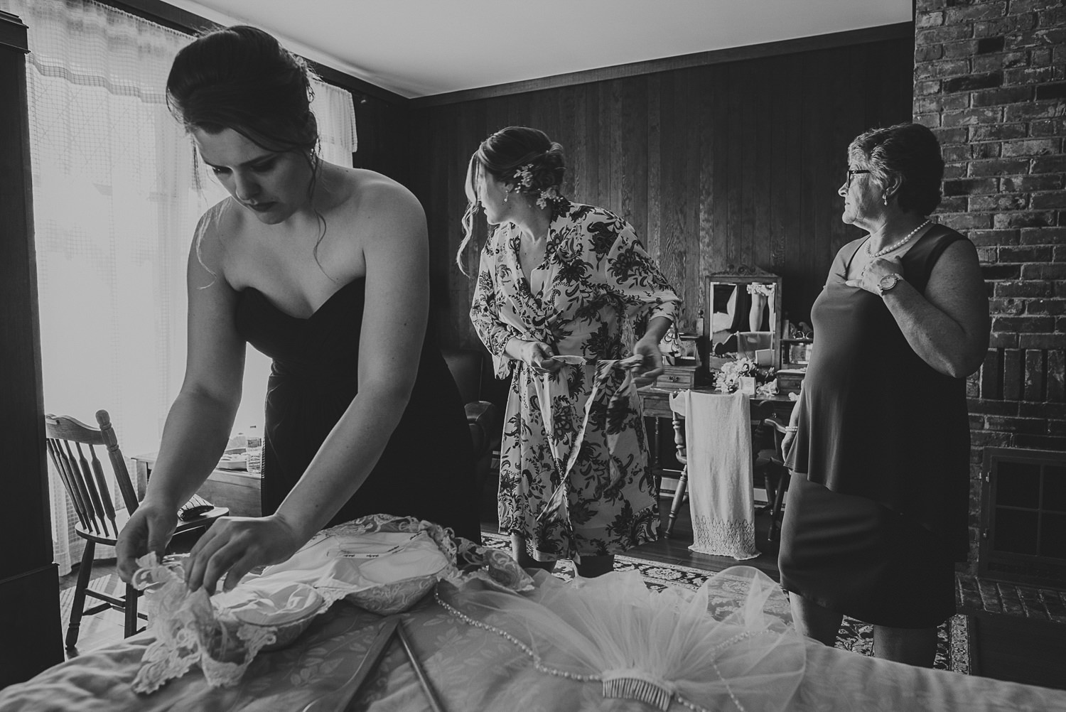 bride & mom looking out window while getting ready at overbury resort thetis island wedding 