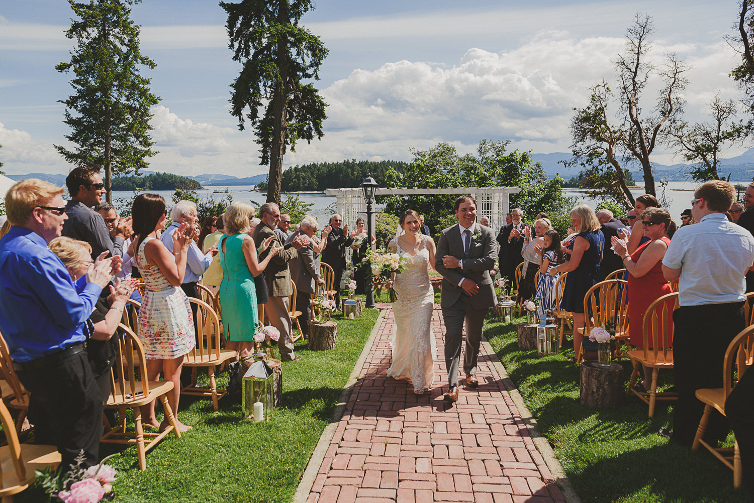 husband & wife walk up the aisle at overbury resort thetis island wedding 