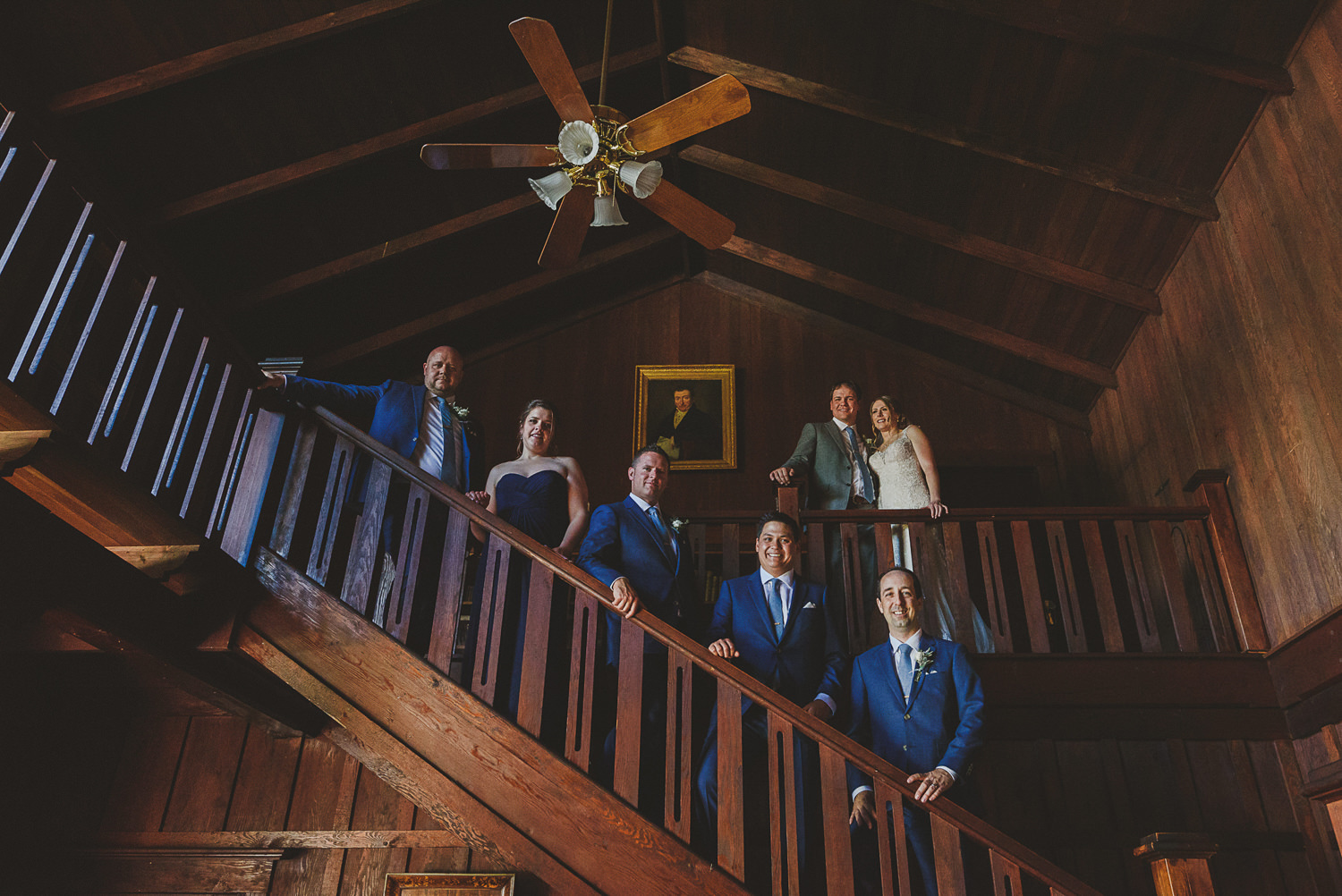 wedding party on staircase at overbury resort thetis island wedding 