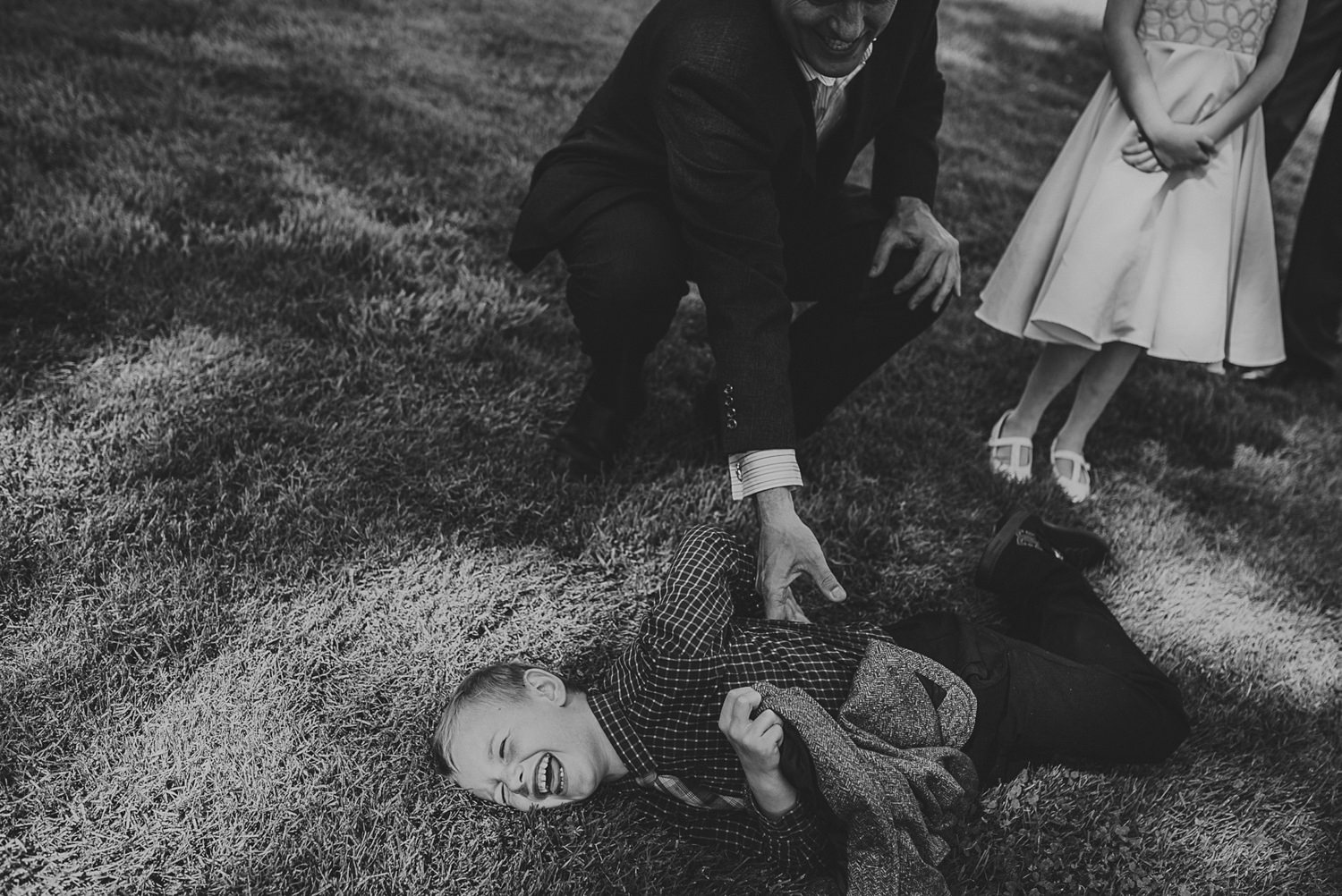 kid being tickled at overbury resort thetis island wedding 