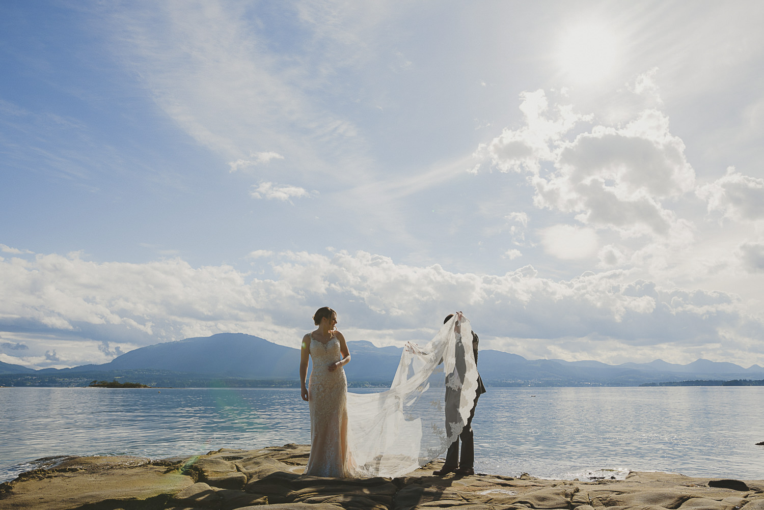 bride & groom overlooking the ocean at the beach at overbury resort thetis island wedding 