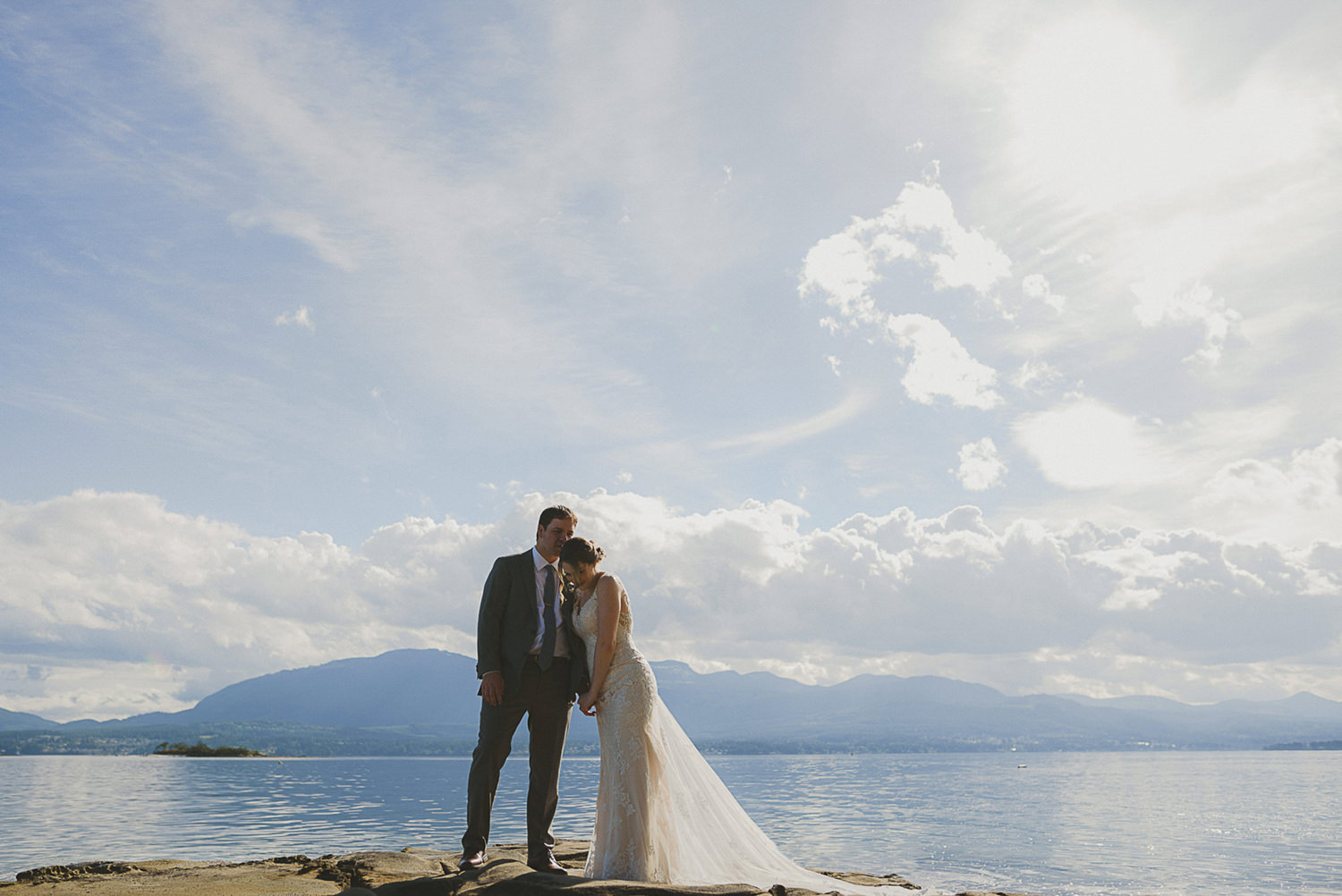 bride & groom overlooking the ocean at the beach at overbury resort thetis island wedding 