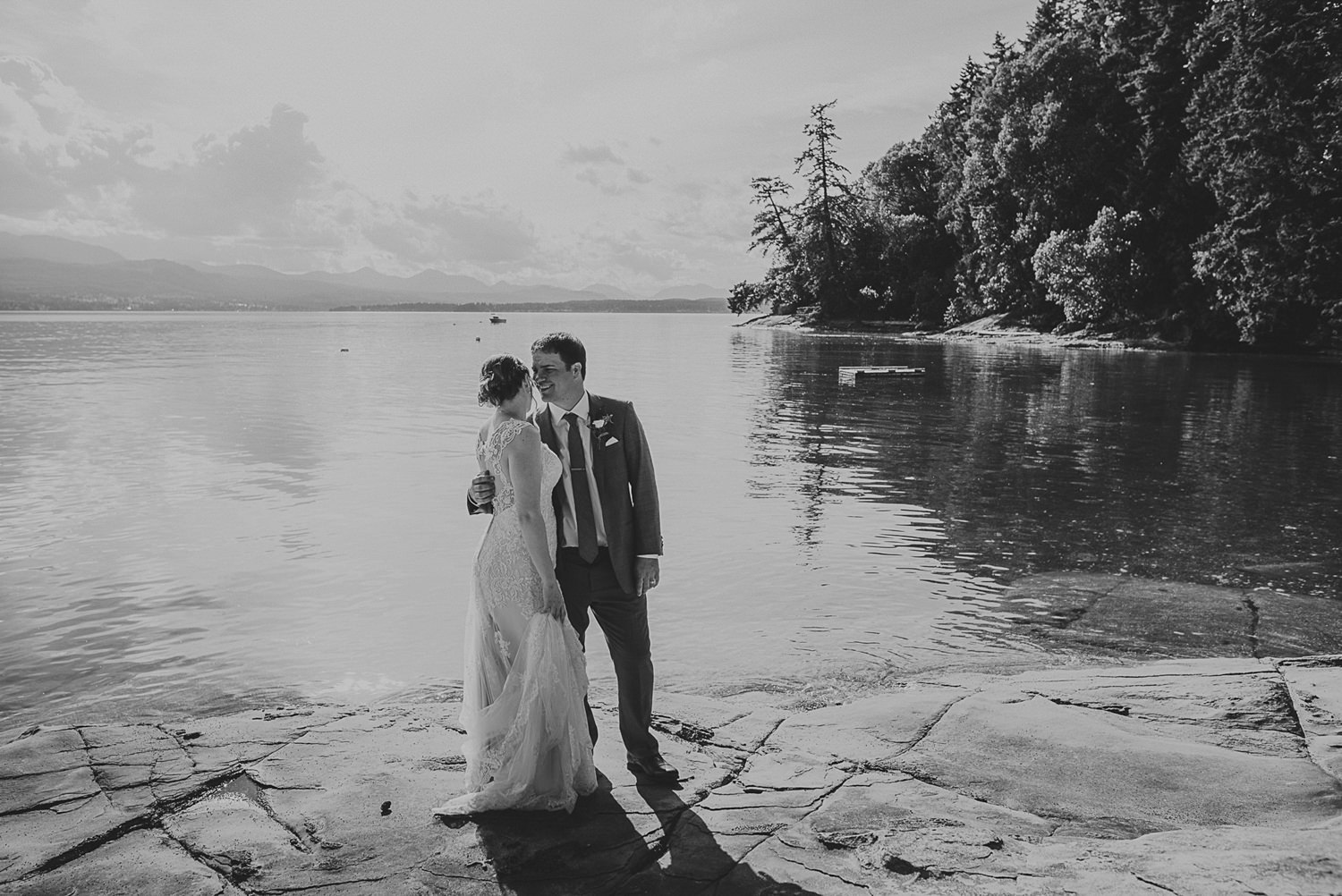 bride & groom kissing on the waterfront at overbury resort thetis island wedding 