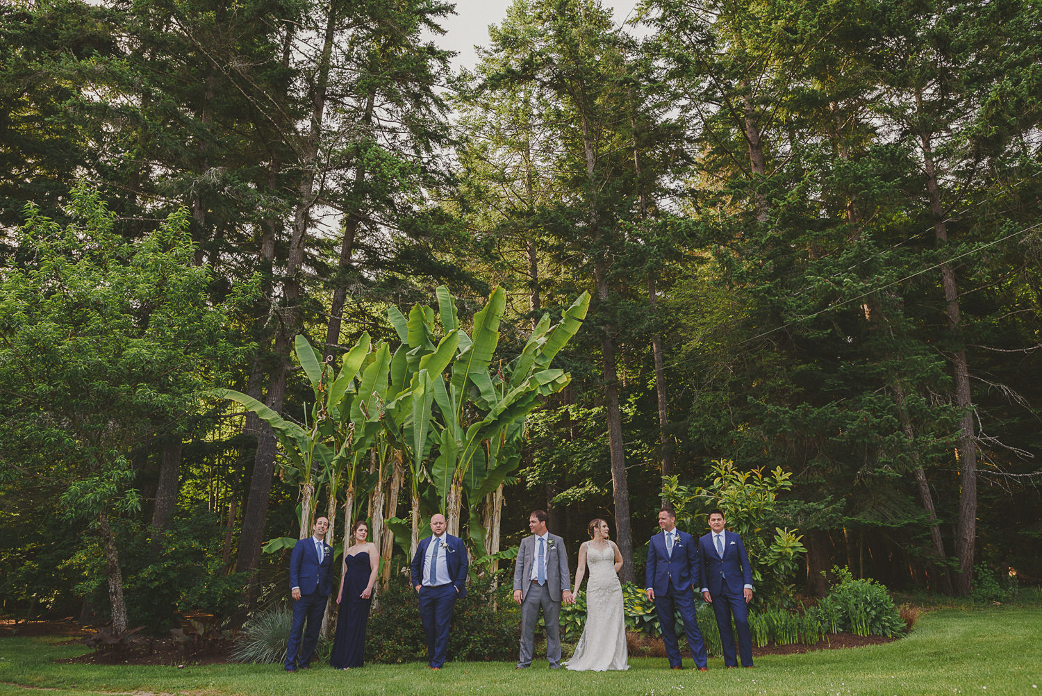 wedding party in front of forest at overbury resort thetis island wedding 
