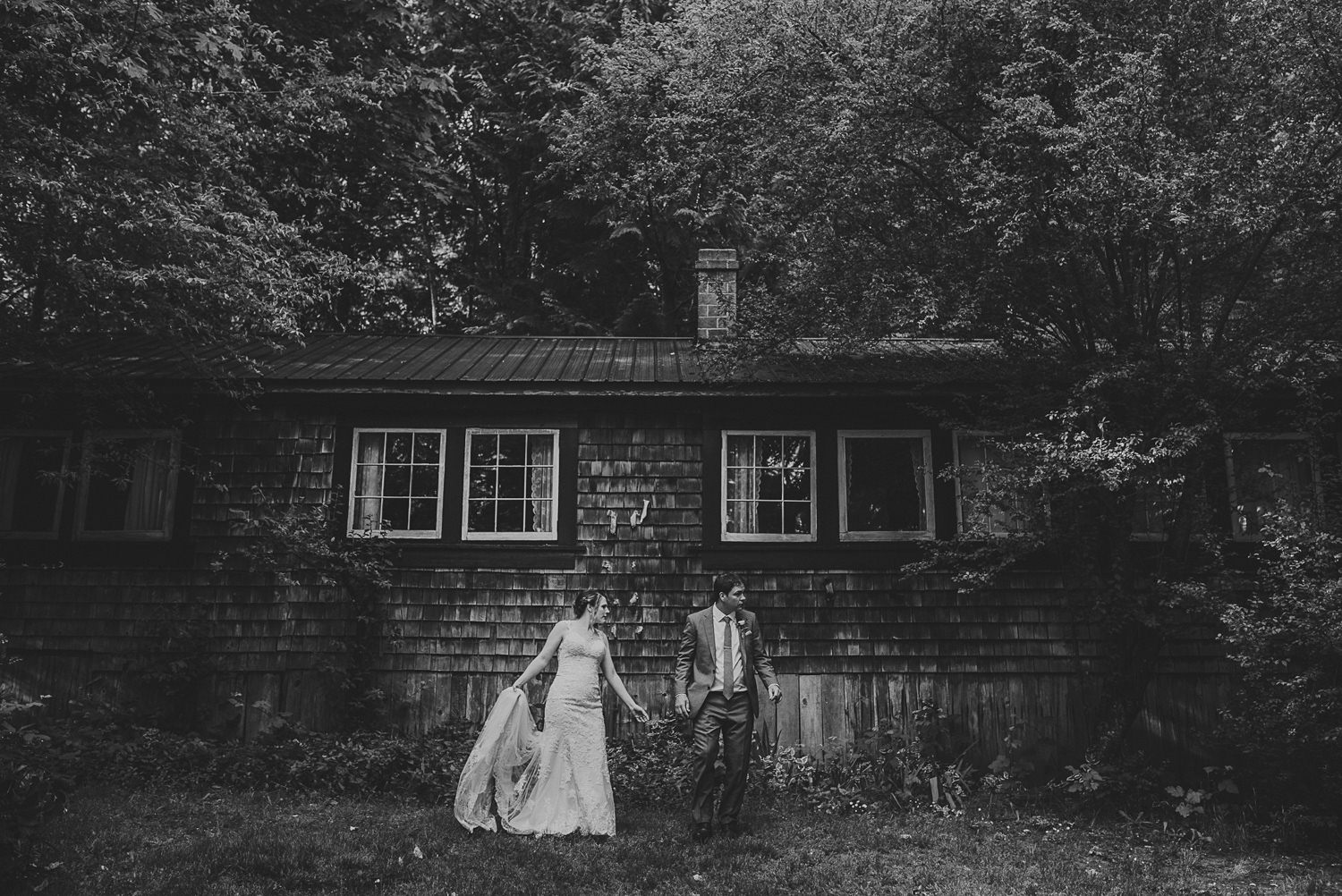 bride & groom in front of rustic cabin at overbury resort thetis island wedding 