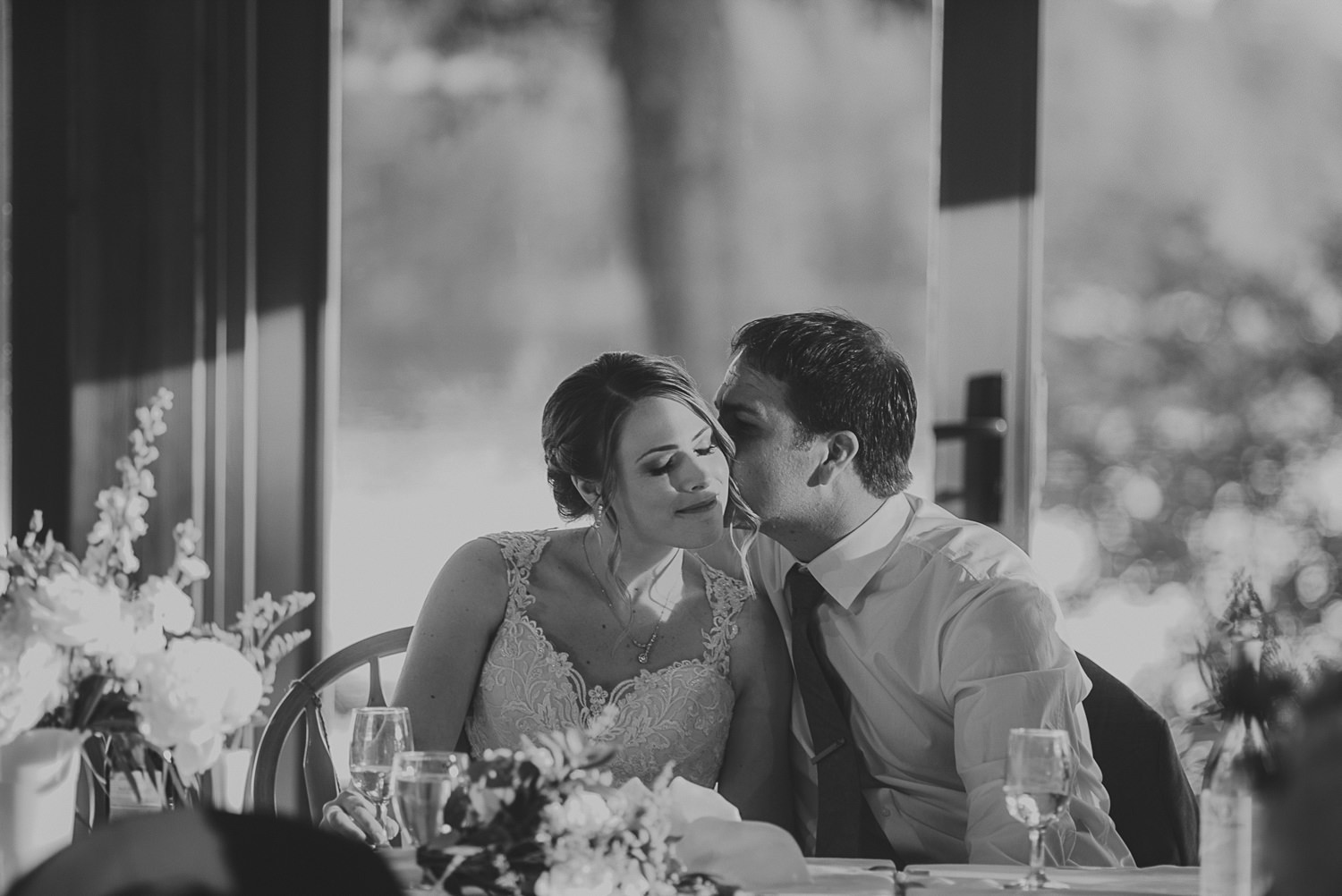 groom kissing bride at overbury resort thetis island wedding 