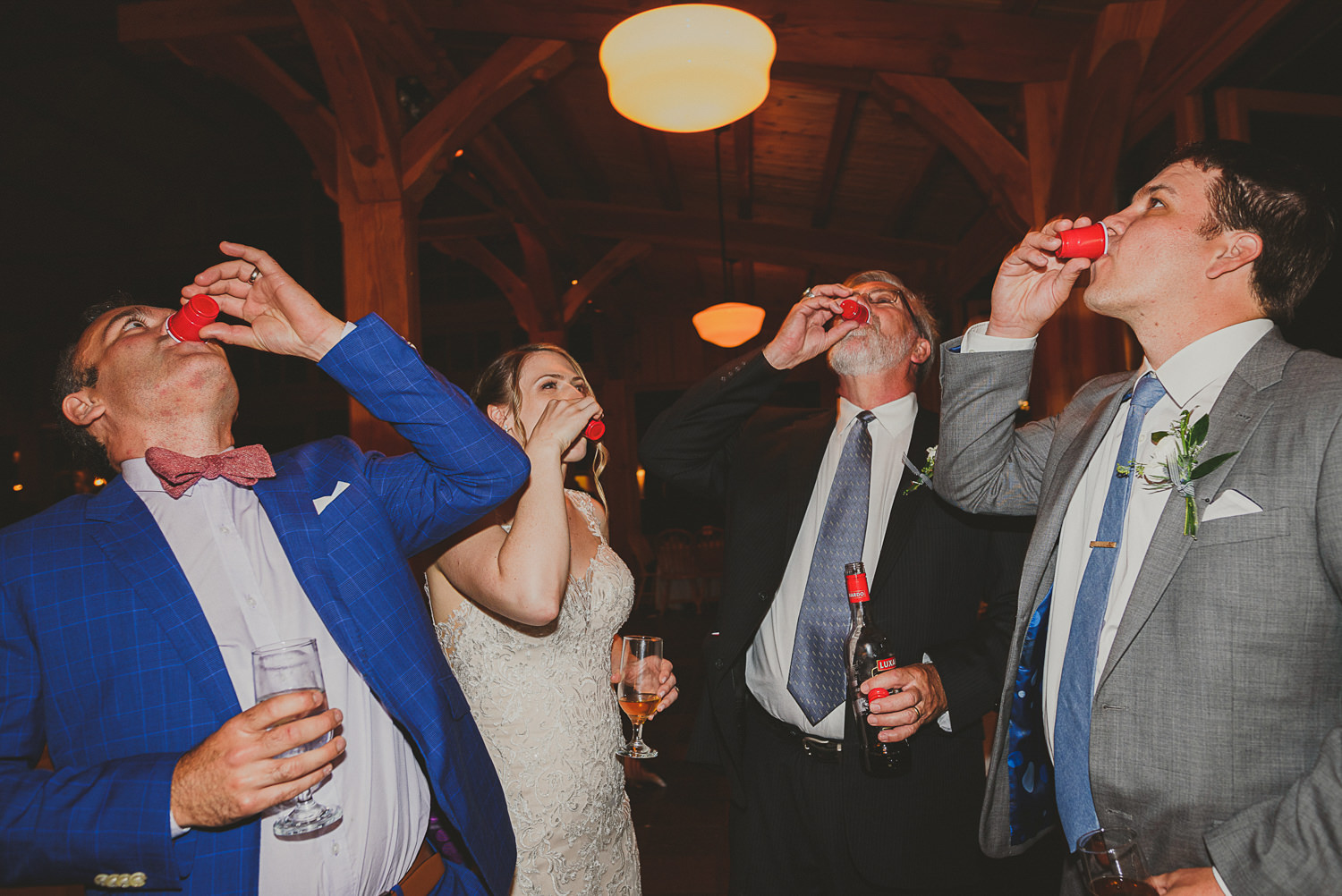 bride & groom & guests doing shots at overbury resort thetis island wedding 