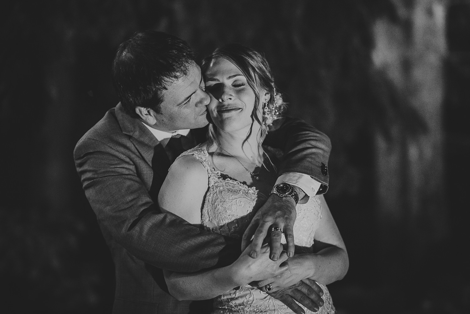 groom kissing bride at overbury resort thetis island wedding 