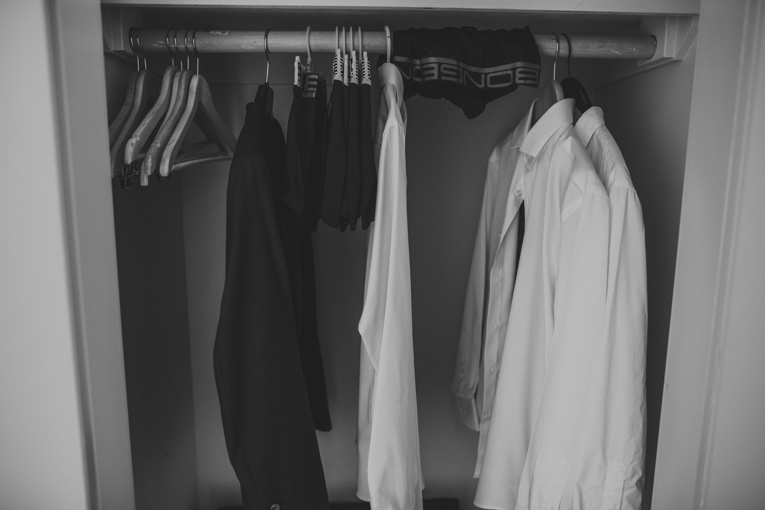 groom’s & groomsmen’s shirts hanging in closet