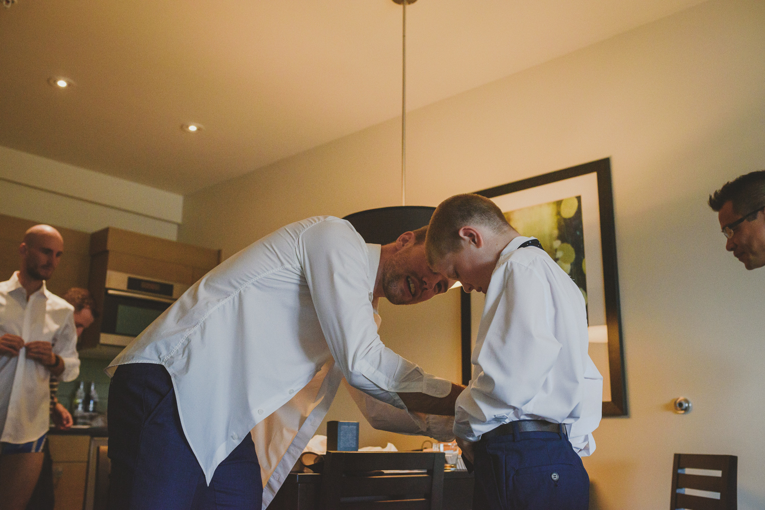 groom helping younger brother get ready-black rock resort west coast wedding