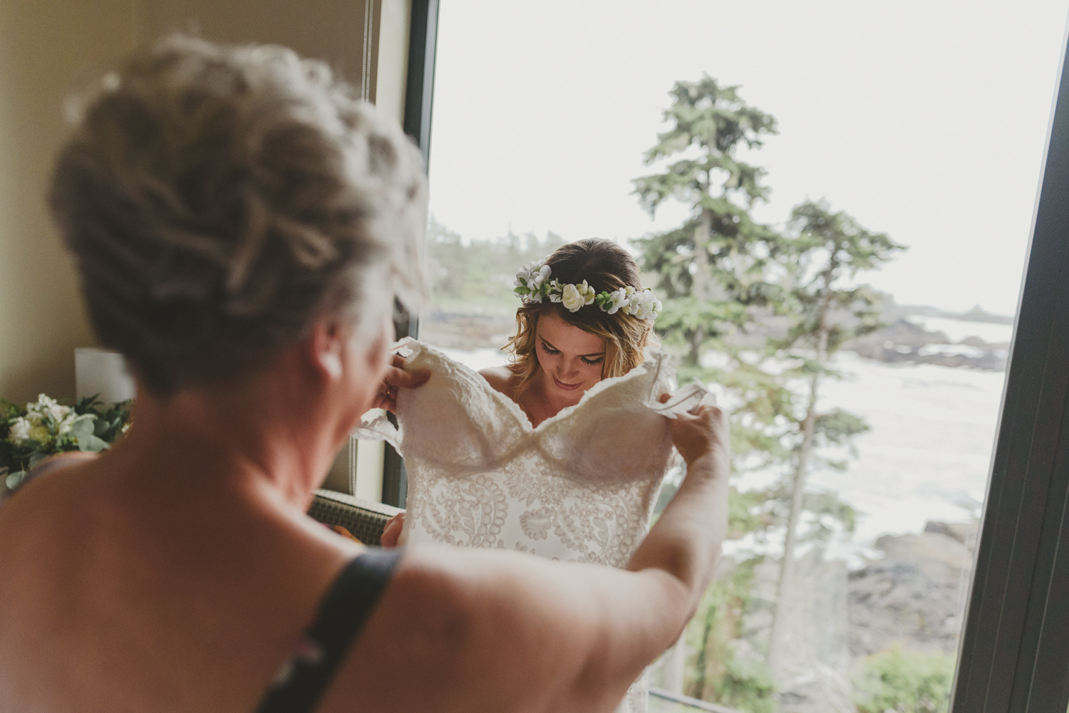 bride’s mother helping her into her dress-black rock resort west coast wedding