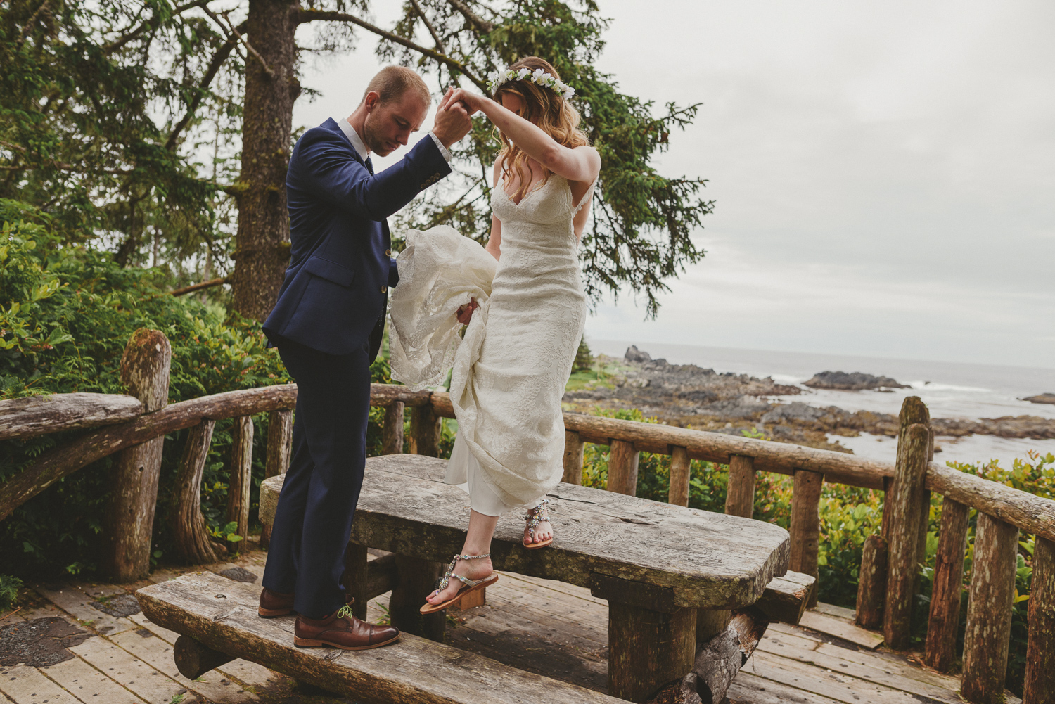 groom helping bride off picnic table-black rock resort west coast wedding