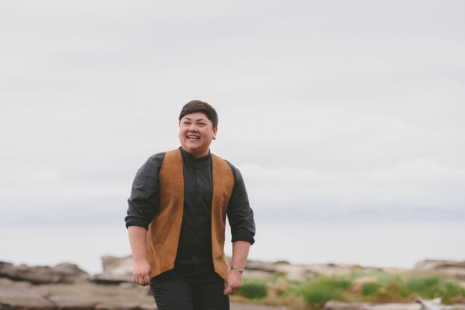 lgbtq jewish pagan metis wedding at sea breeze lodge on hornby island partner smiling awaiting bride