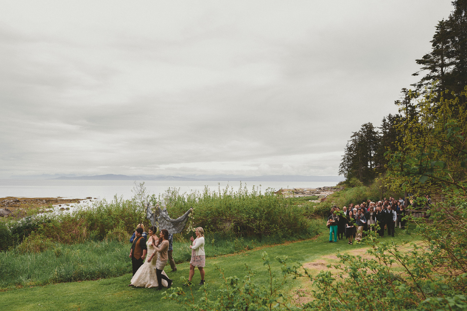 lgbtq jewish pagan metis wedding at sea breeze lodge on hornby island walking to the beach