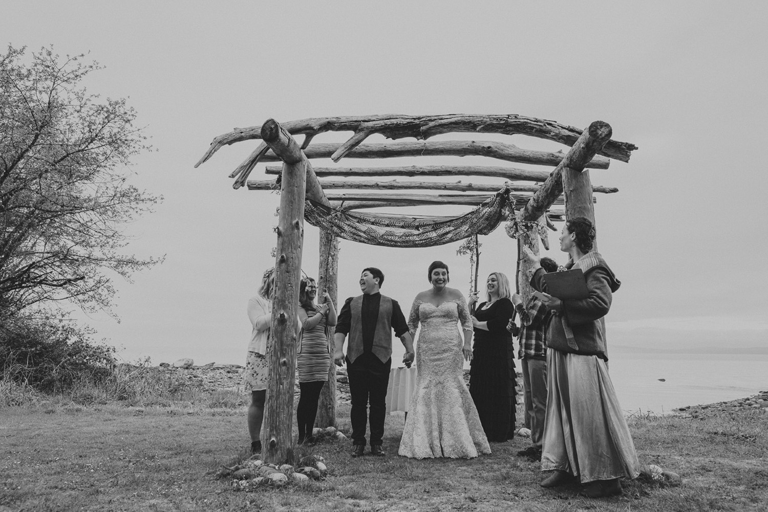 lgbtq jewish pagan metis wedding at sea breeze lodge on hornby island couple under chuppah