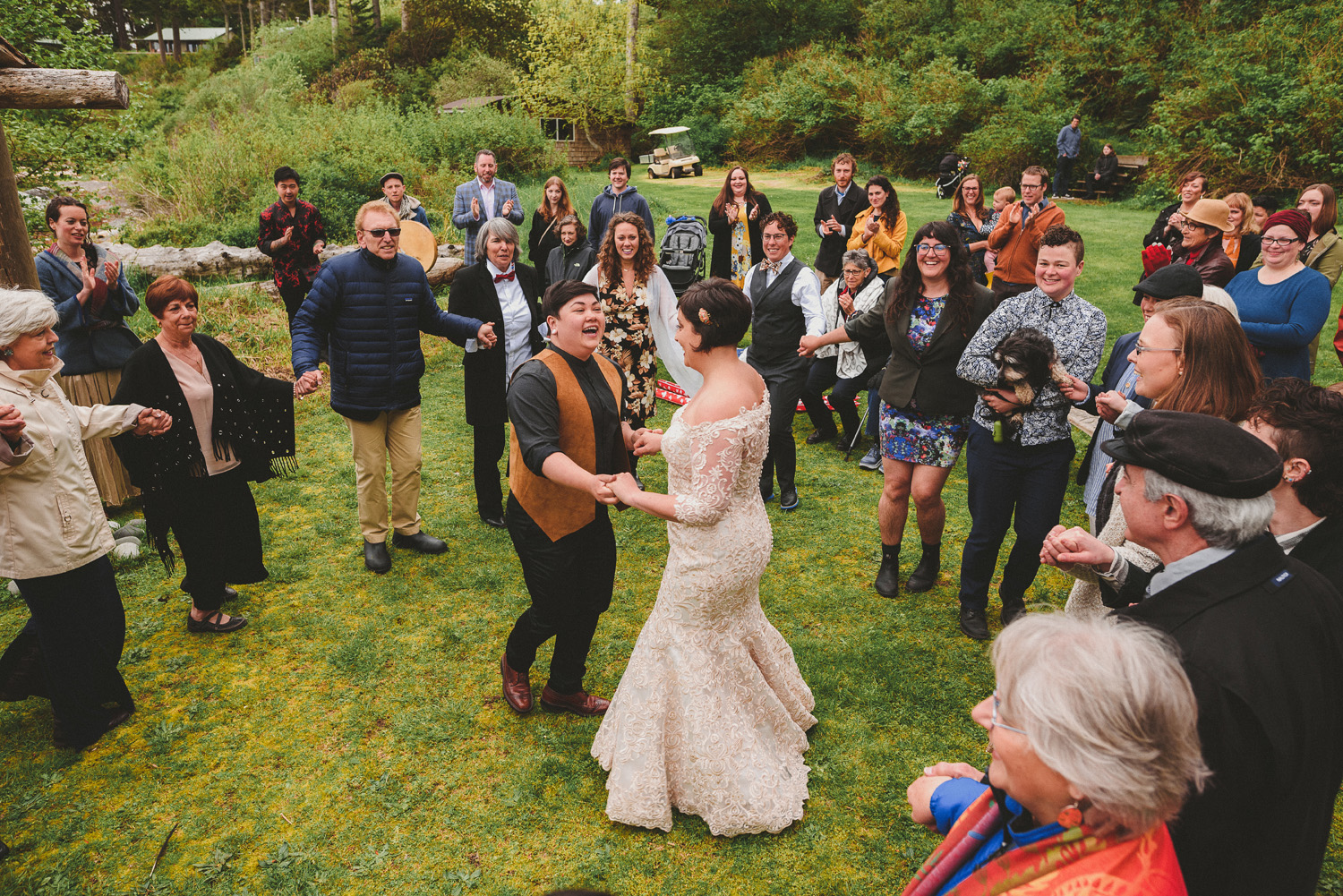 lgbtq jewish pagan metis wedding at sea breeze lodge on hornby island couple dancing surrounded by guests