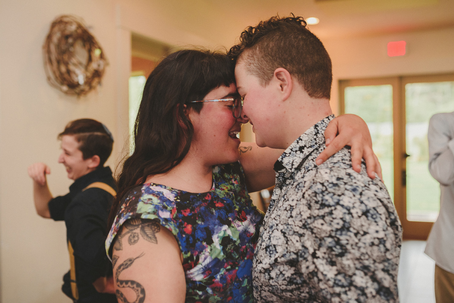 lgbtq jewish pagan metis wedding at sea breeze lodge on hornby island guests kissing