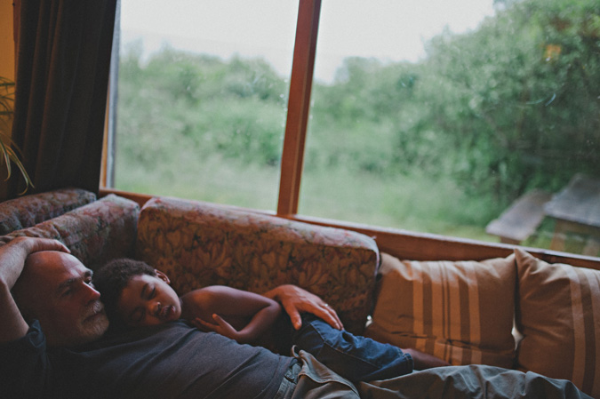 father & child sleeping on the couch