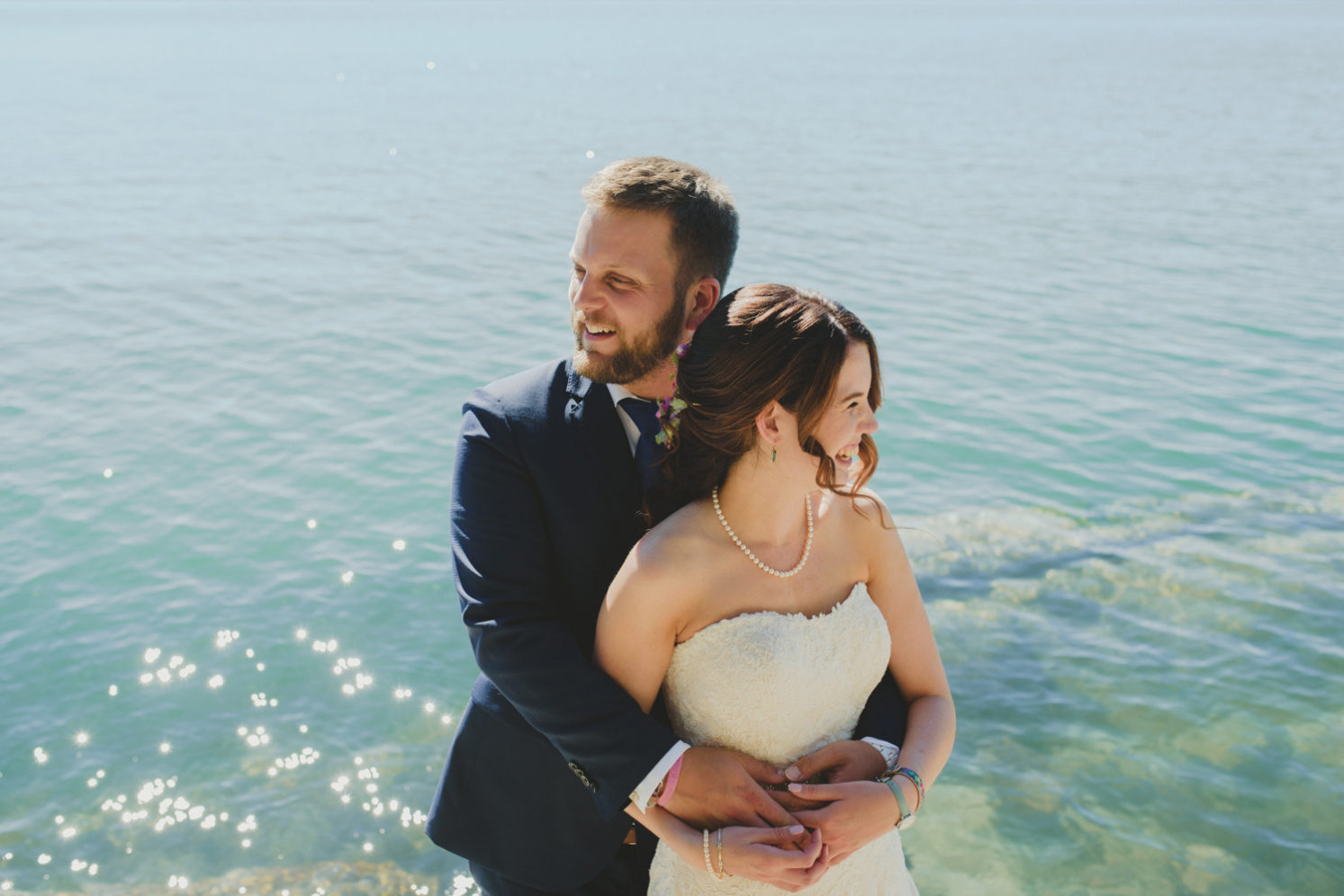 intimate bodega ridge wedding - galiano island - couple hugging in front of sparkling ocean
