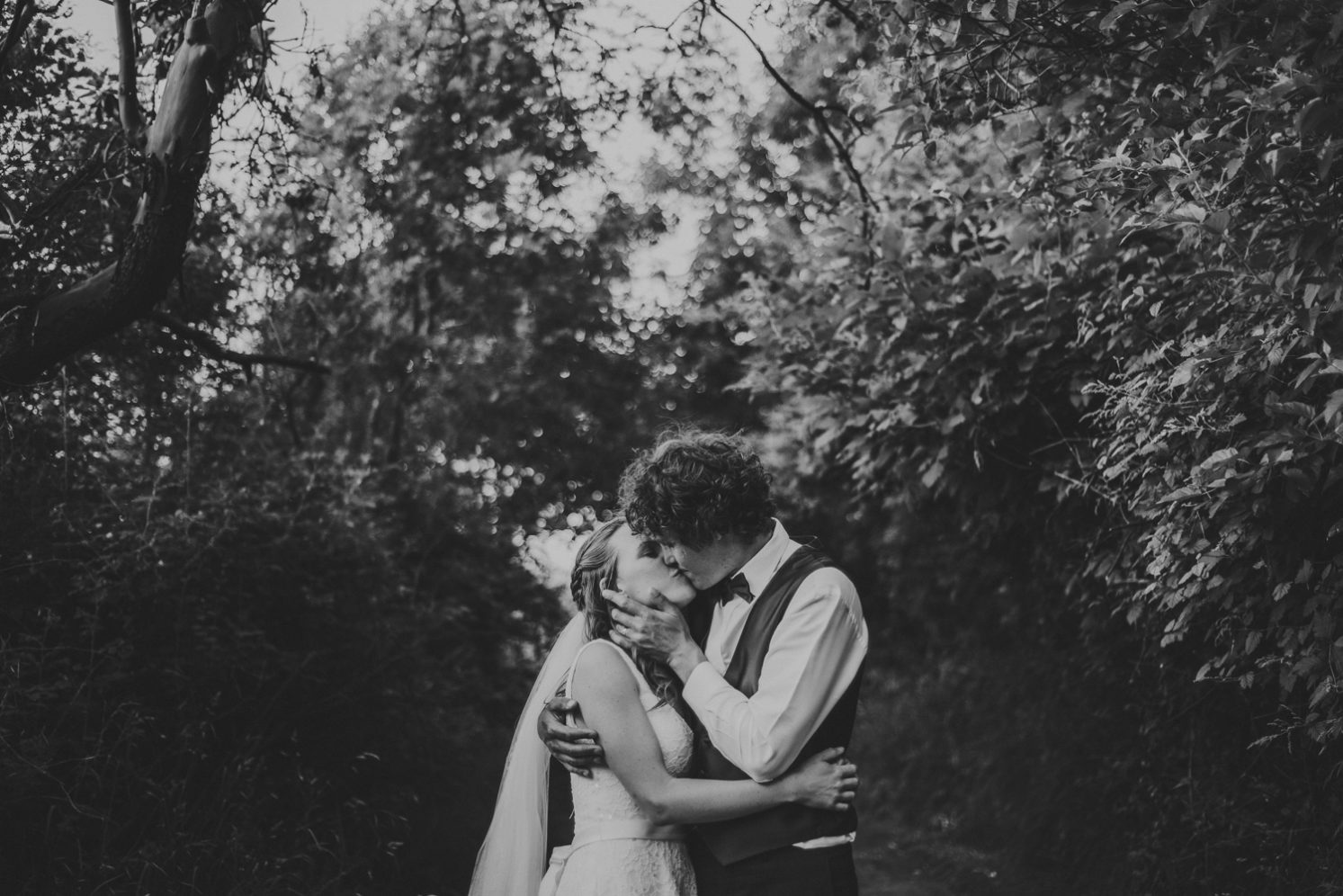 intimate moment of bride & groom kissing