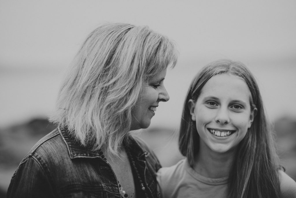 black & white photo of a mom & her young teenage daughter