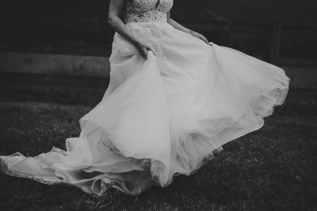 close up of bride's wedding dress while she walks