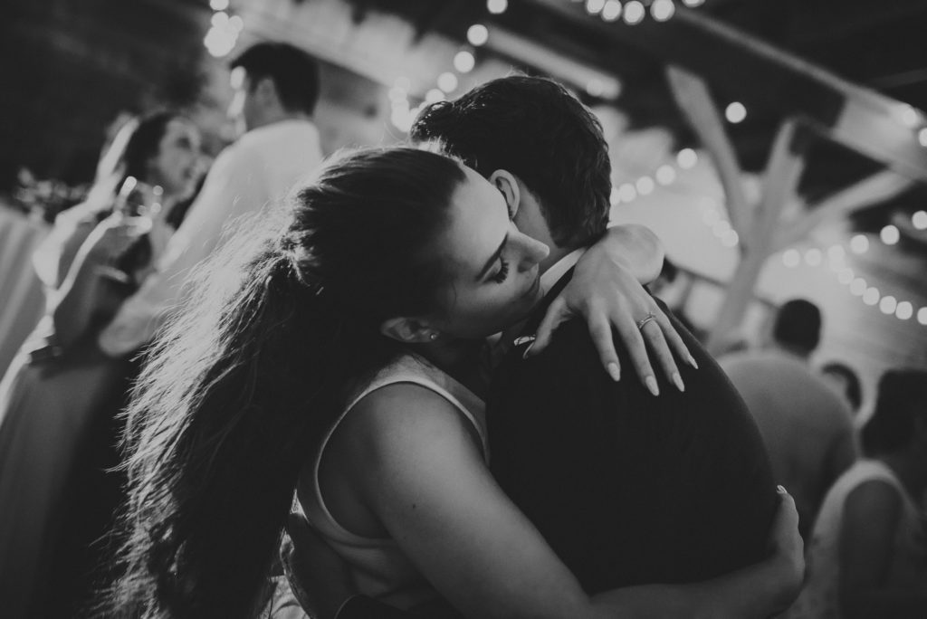close up of bride & groom embracing during their first dance