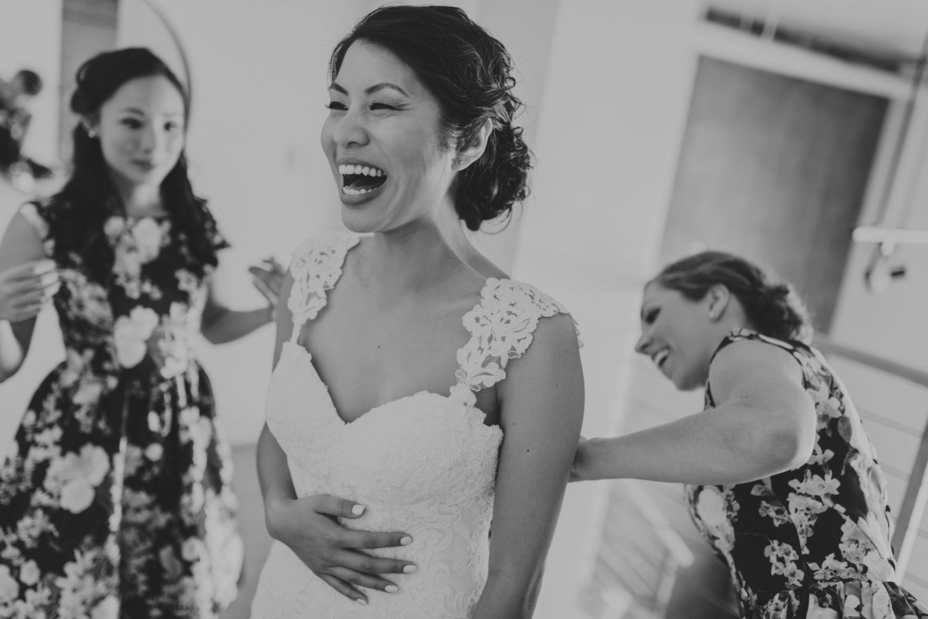 beautiful asian bride laughing with getting ready