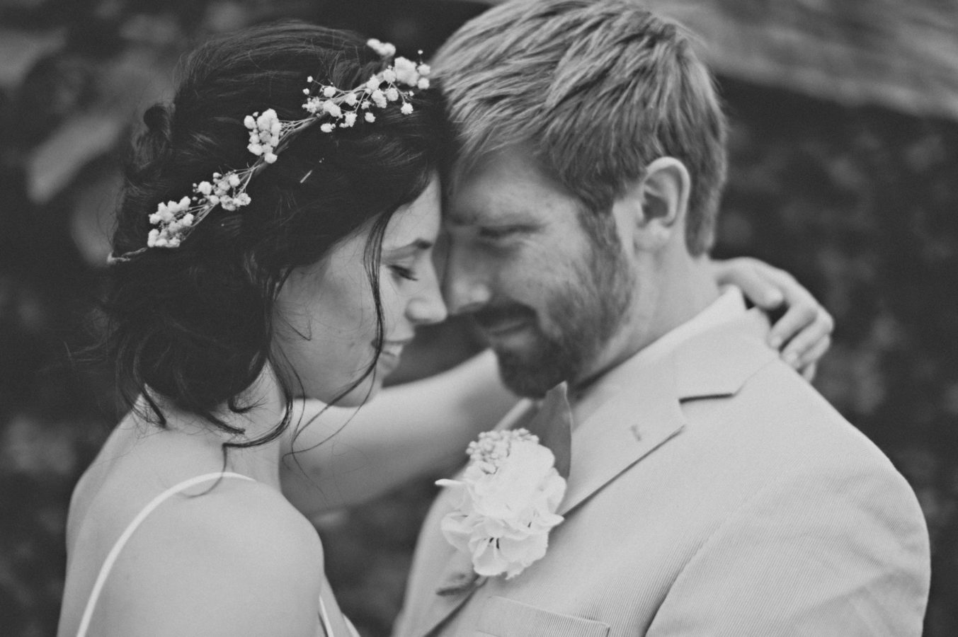 close up of bride and groom with their foreheads together smiling on their wedding day